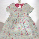 Toddler girl wearing soft rainbow print dress size 2T on white background