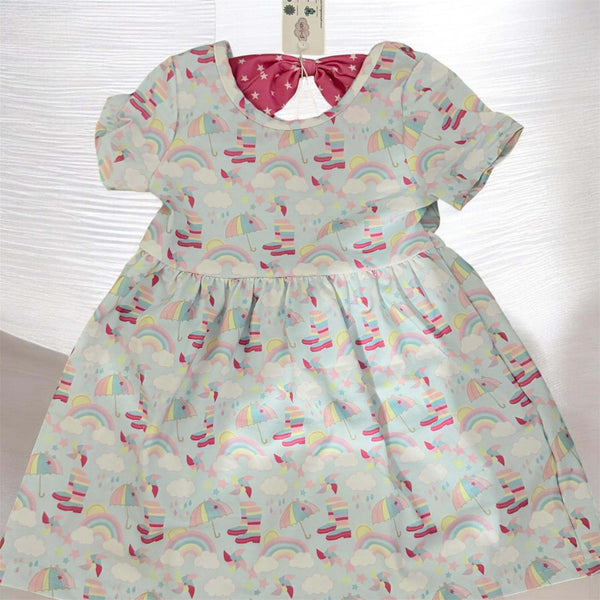 Toddler girl wearing soft rainbow print dress size 2T on white background